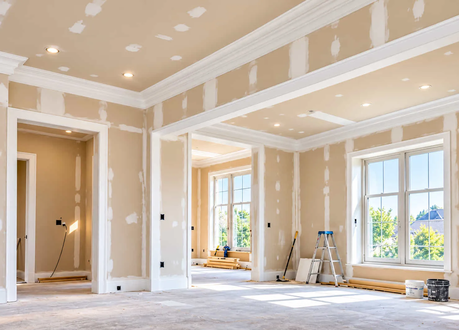 Open-plan room with taped plasterboard walls and ceiling ready for finishing
