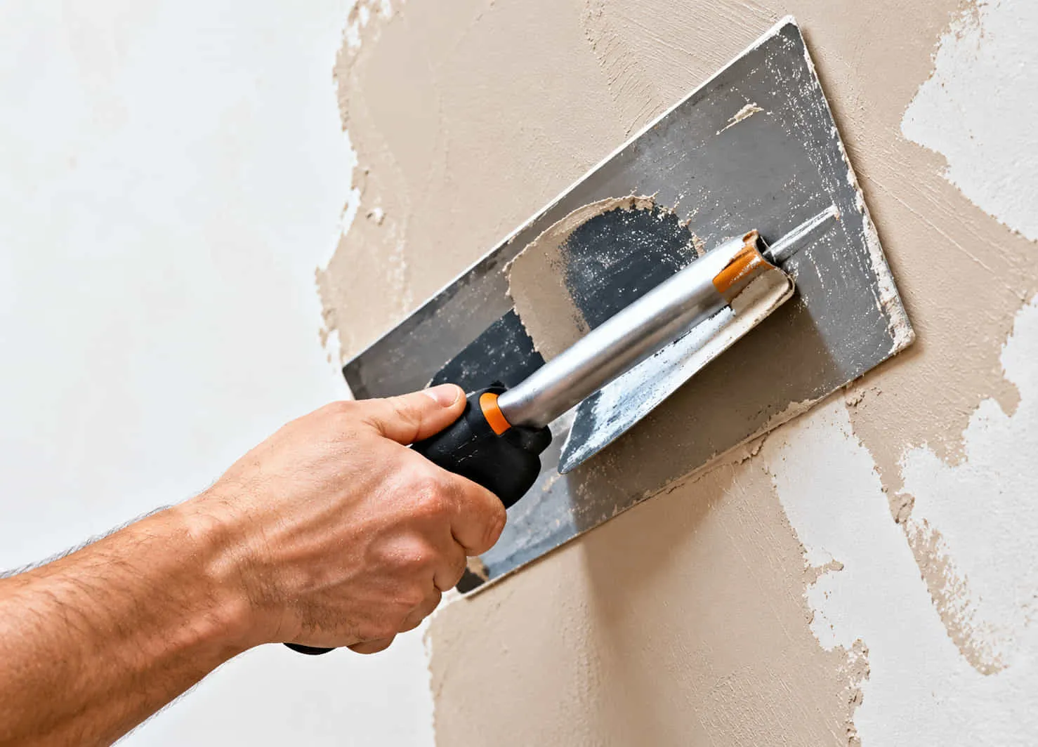 Skim coat being applied over an old ceiling